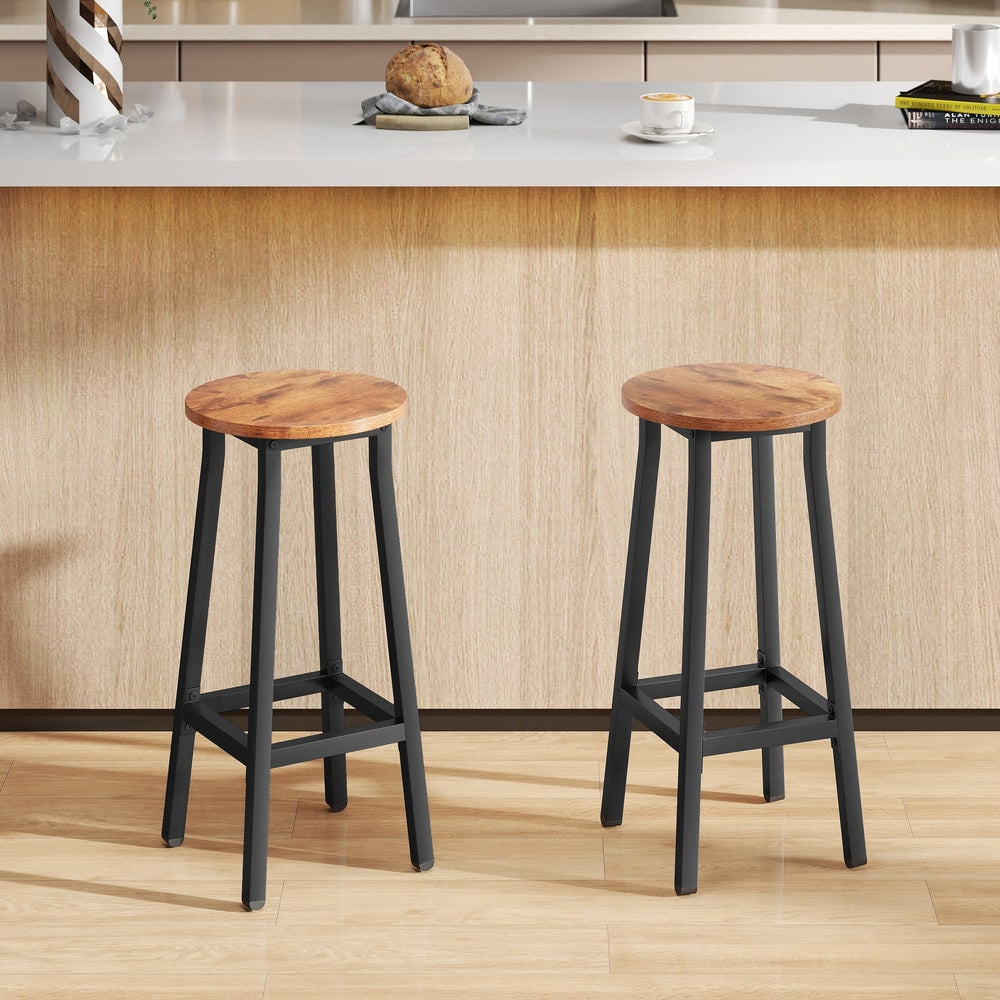 The breakfast bar stools placed in a modern kitchen setting in front of a wooden counter