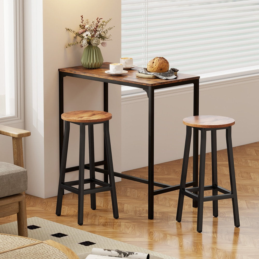 The breakfast bar stools positioned by a small table near a window in a bright living space