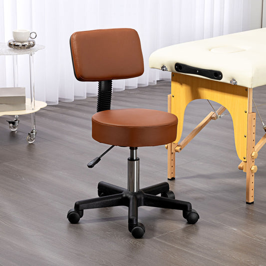 The brown swivel salon chair next to a massage table in a room setting