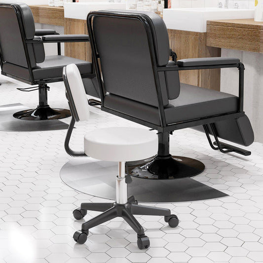 The salon stool placed in a professional hairdressing studio next to a larger black chair