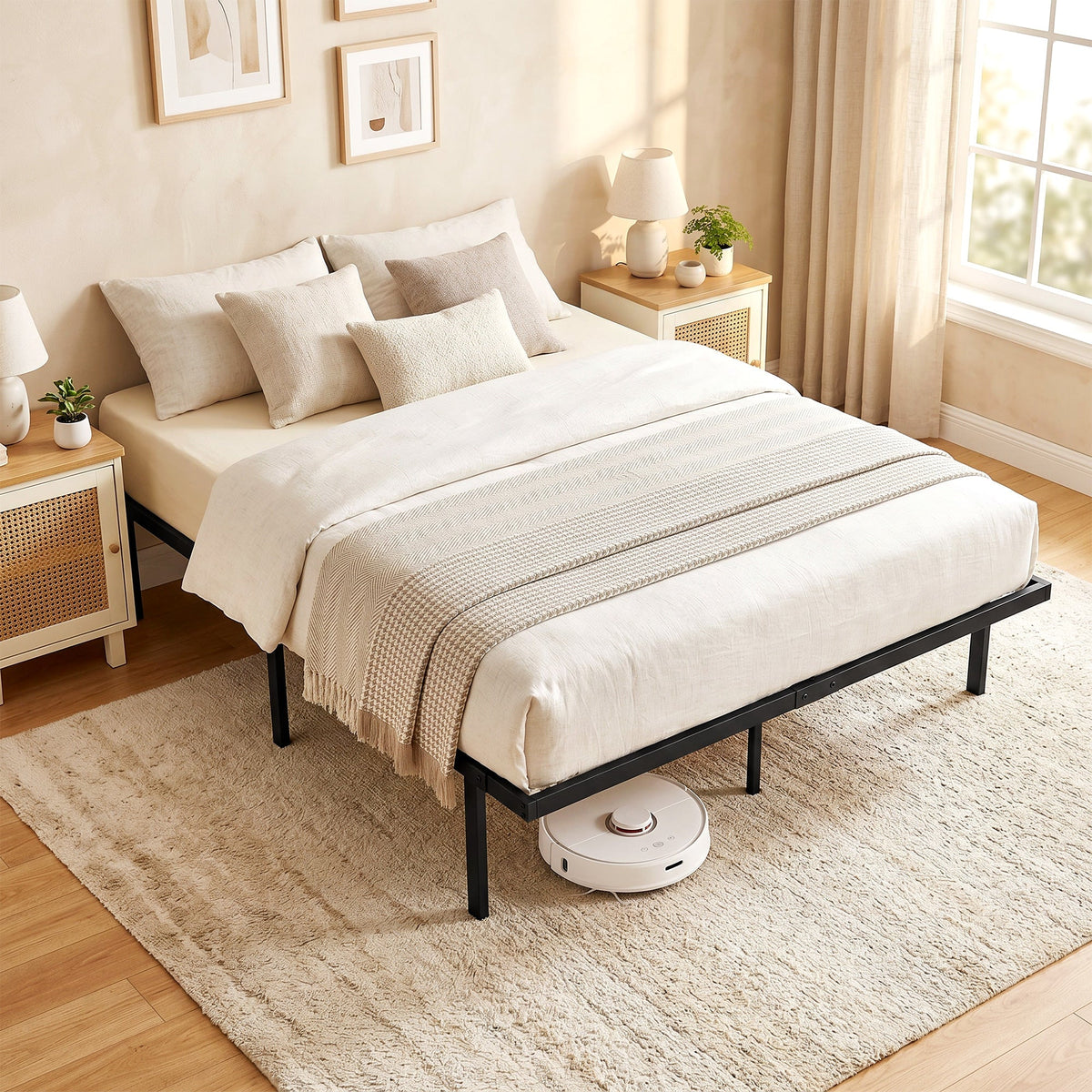 The king size bed frame is set up with a mattress and bedding in a bright bedroom with a robot vacuum underneath