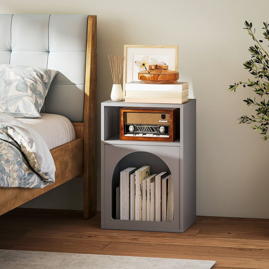 HOMCOM Bedside Table with 2 Open Compartments, the grey storage cabinet placed next to a bed, holding books and decorative