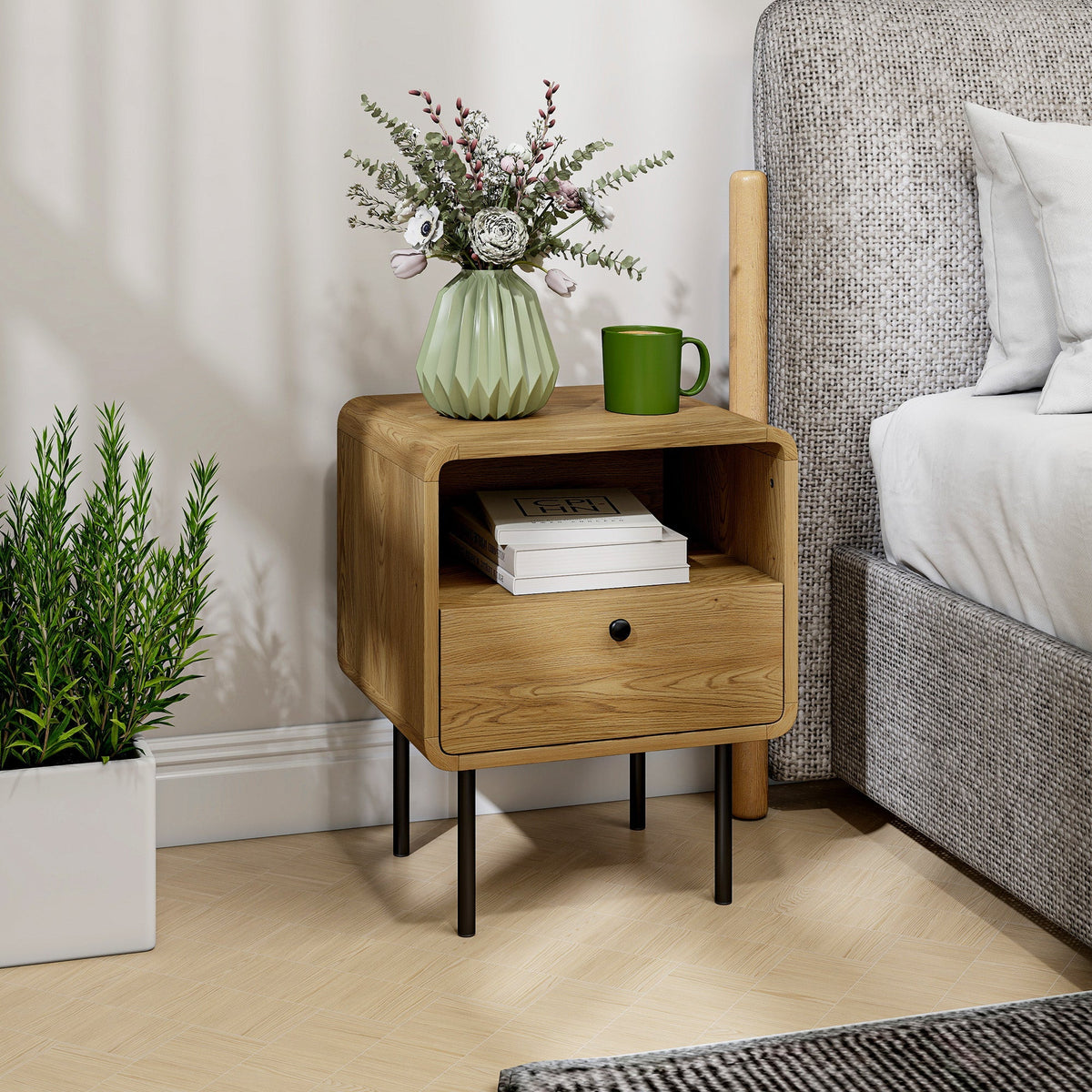 Oak bedside cabinet with a drawer and open shelf next to a bed