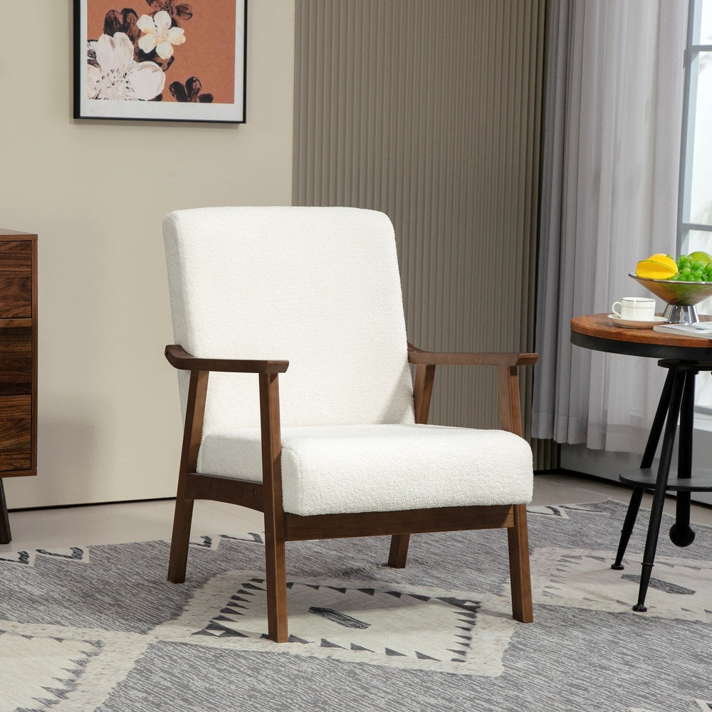 White boucle fabric armchair with wooden legs and arms in a room setting