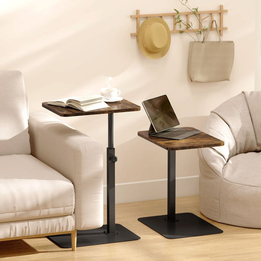Two small end tables, one with a laptop and the other with a book, placed next to a sofa