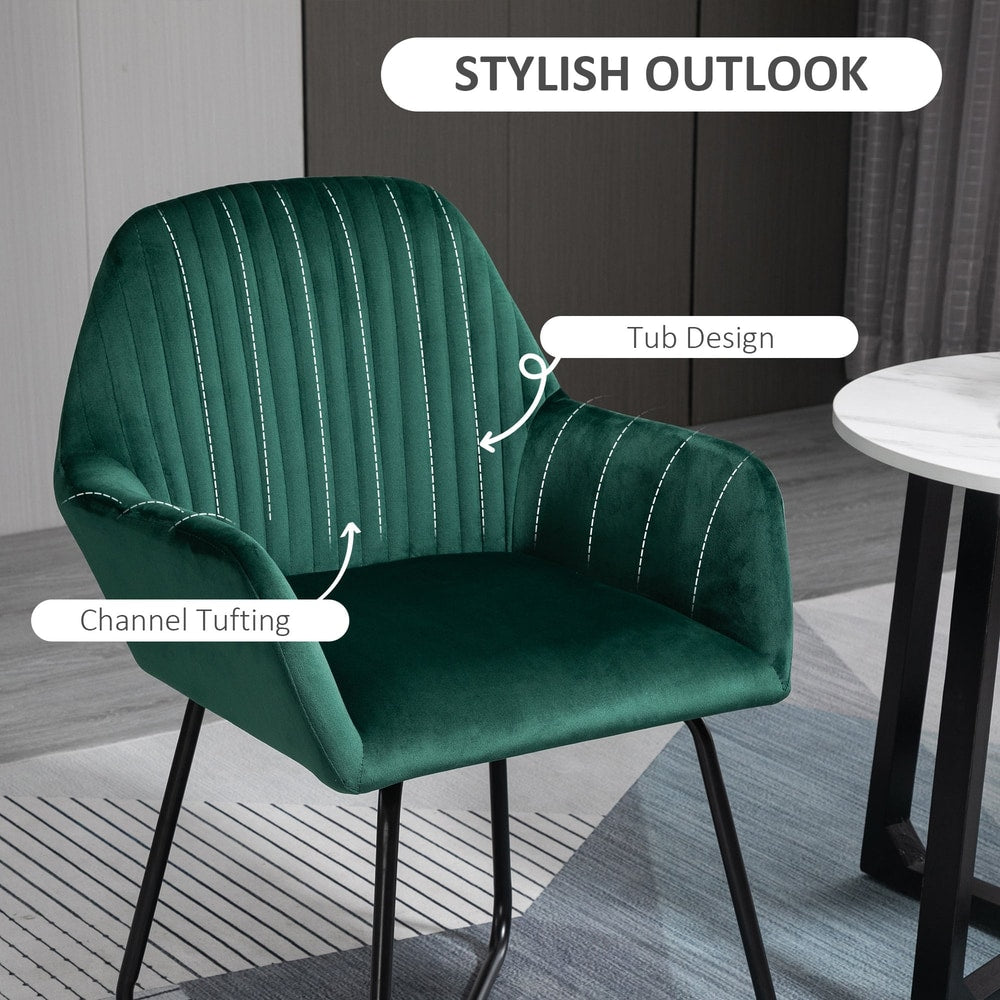 Close up of a green velvet-feel accent chair showing its channel tufted back