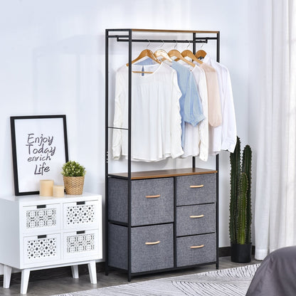The coat rack and drawers unit in a bedroom setting with clothes on the rail and a decorative picture and plant