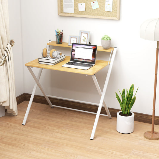 The office desk set up in a home study with a laptop and accessories on the tabletop