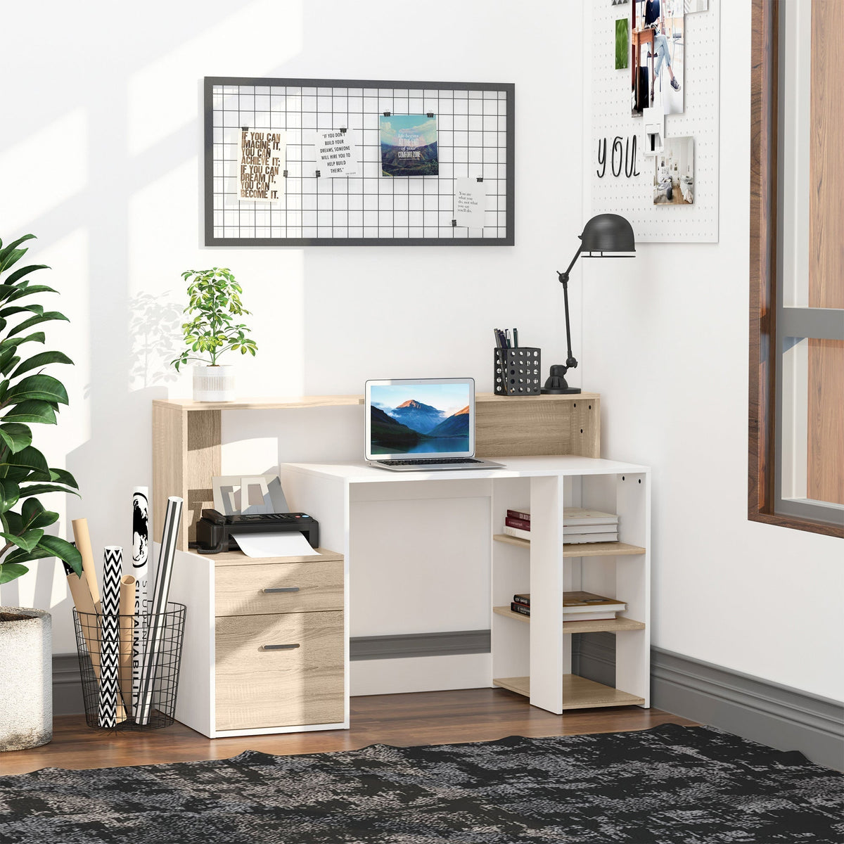 The office desk in a room with a laptop, printer and plant on it, set up for working