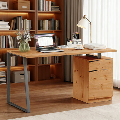 The office desk set up in a home study with a laptop and lamp on the wooden surface