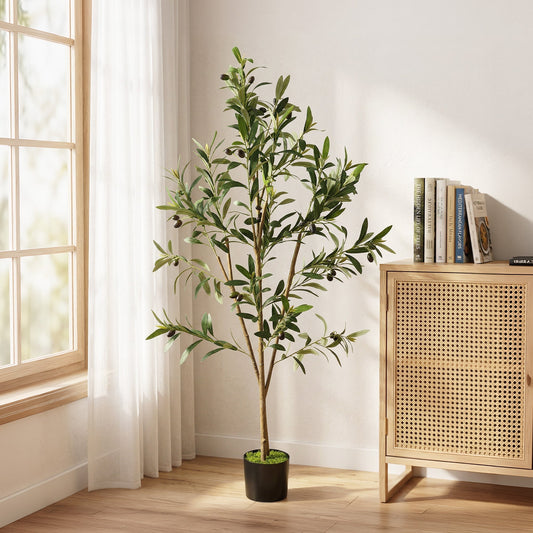 The artificial olive tree placed in a bright room next to a wooden cabinet and window