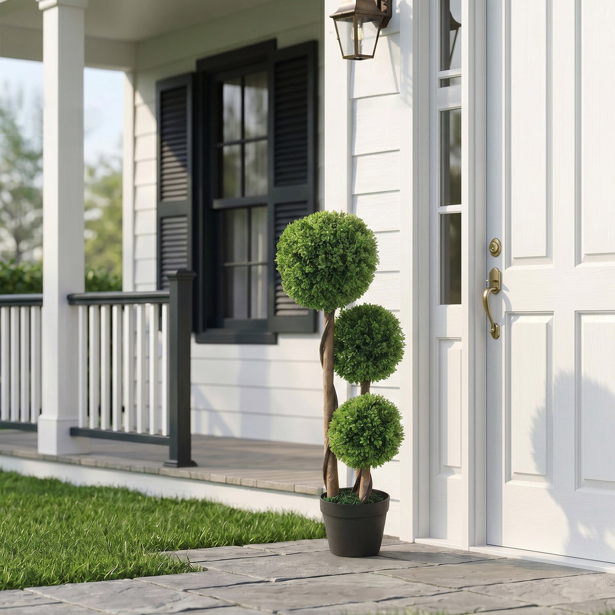 The artificial plants standing by a white front door on a porch