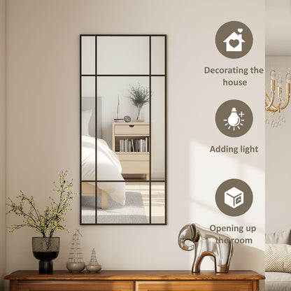 This wall mirror is shown in a bedroom reflecting a bed and bedside table
