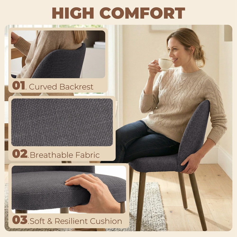 Close-up details of the dark grey upholstered dining chairs showing the curved backrest, fabric texture and padded seat