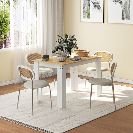 The dining table set in a bright room with four chairs and decorative items on top