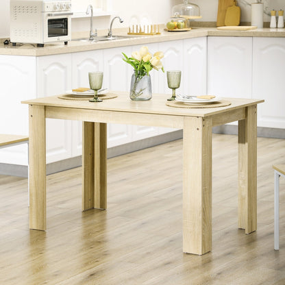 The dining table set up with plates and glasses in a modern kitchen