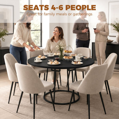 The dining furniture in a home setting with four people seated around it for a meal
