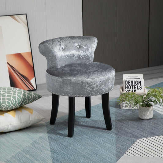The vanity stool placed on a patterned rug in a modern living room setting