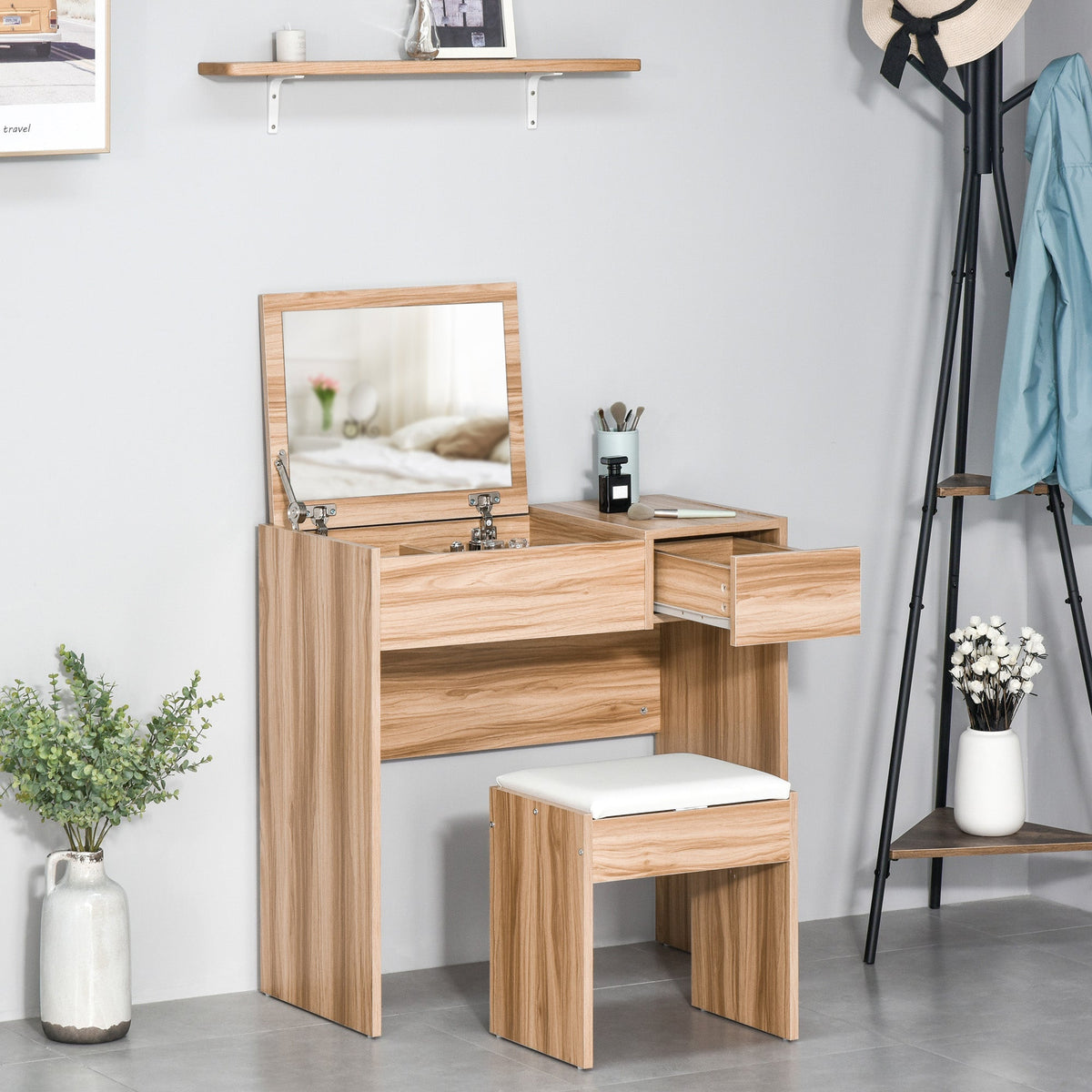 A dressing table with a flip-up mirror and cushioned stool, with the storage drawer pulled out