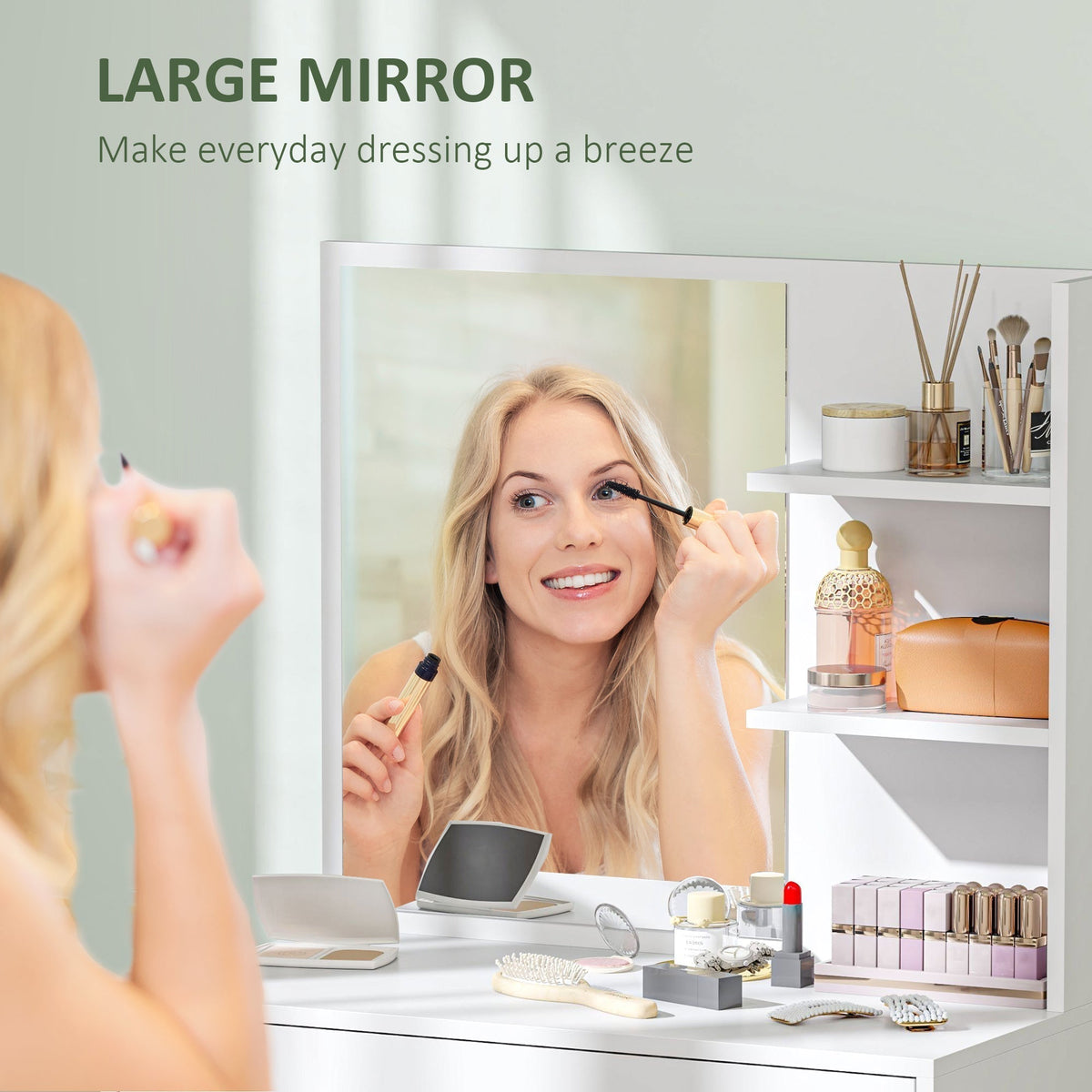 A woman applying mascara while looking into the mirror of the dressing table