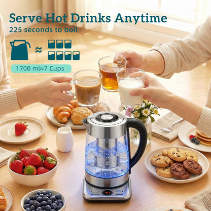 The electric water kettle in use on a table surrounded by people holding cups of hot drinks