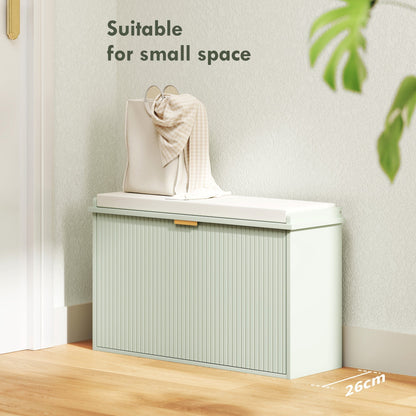 The shoe storage bench closed with a bag on top in a small hallway space