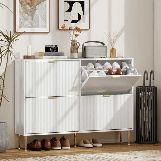 White four-drawer shoe cabinet in a hallway with shoes inside and decorative items