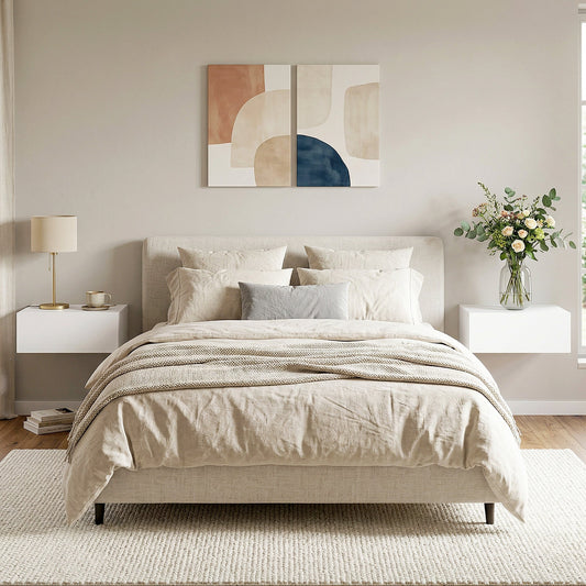 Two white floating bedside tables mounted on a wall either side of a bed