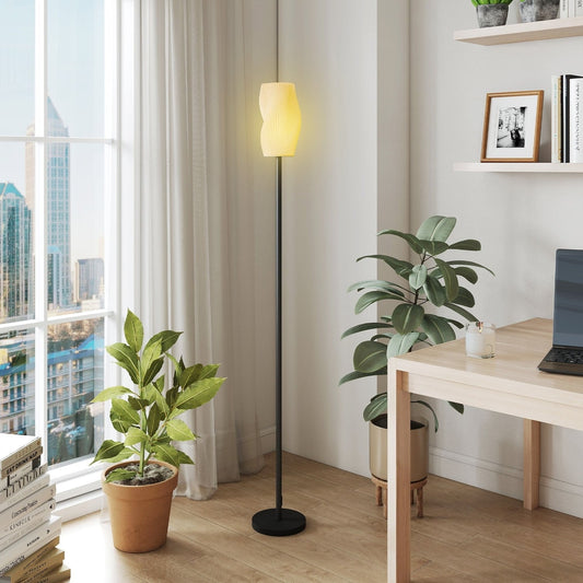 The modern standing lamp in a bright living room next to a window and a desk