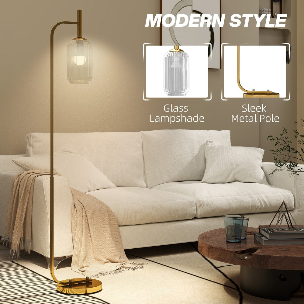 Close up of the glass lampshade and metal pole of the gold floor lamp