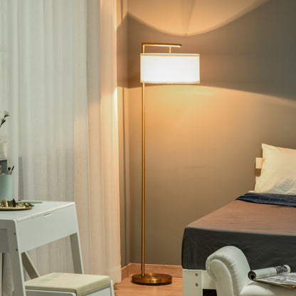 Modern standing light with a gold pole and white shade illuminating a bedroom at night