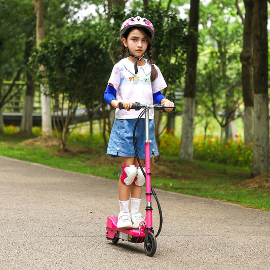 Girl wearing a helmet and pads riding the pink electric scooter on a path