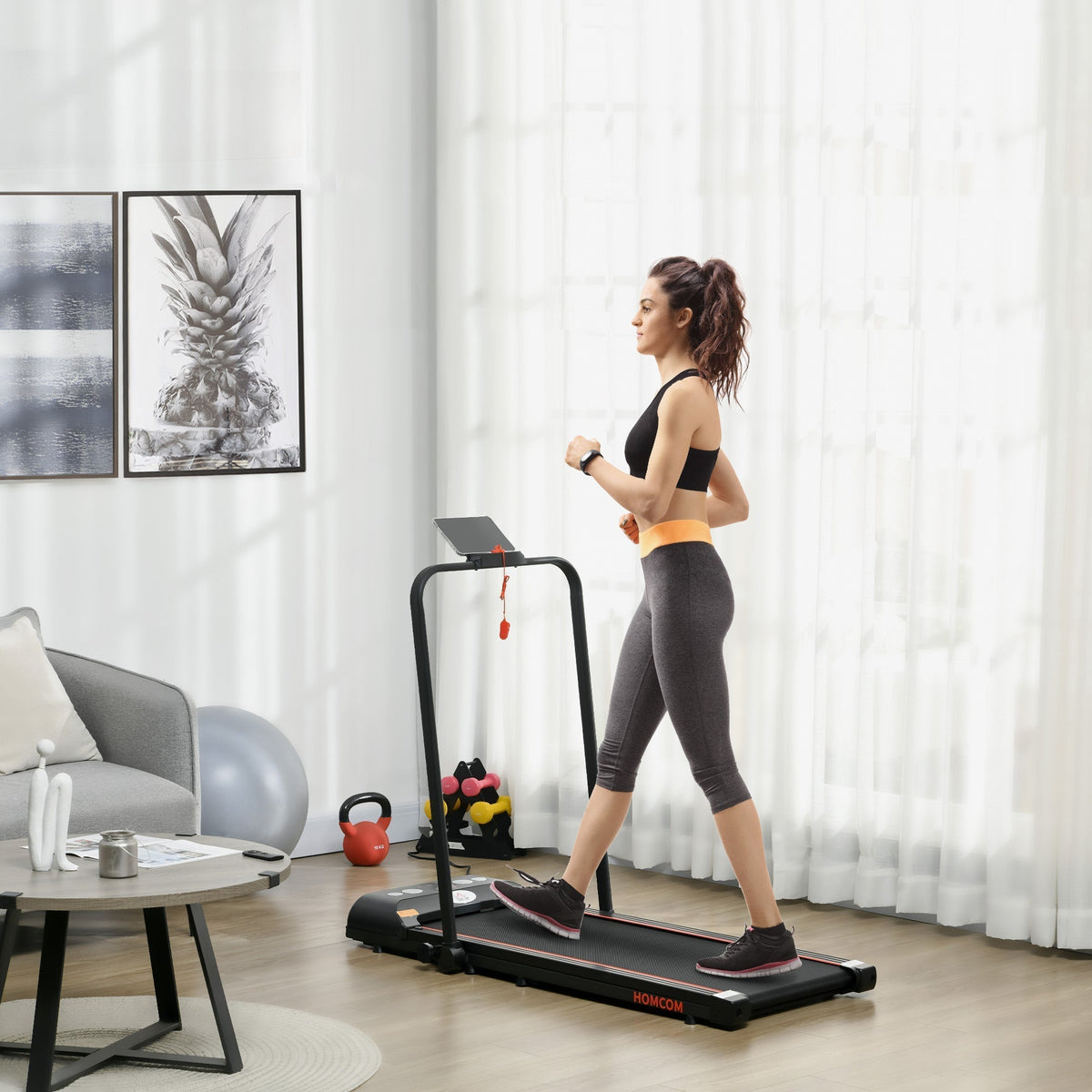 Woman walking on the red foldable walking treadmill in a living room