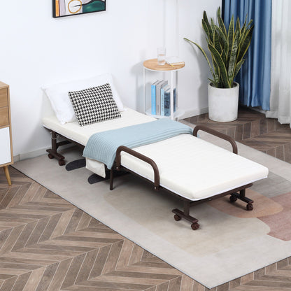 The guest bed set up in a living room with a pillow and blanket on top of the mattress