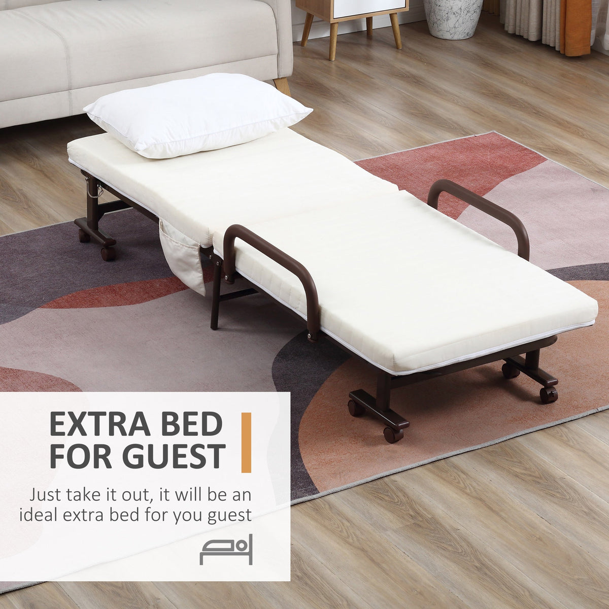 The portable guest bed placed on a rug in a living room with a pillow on the mattress
