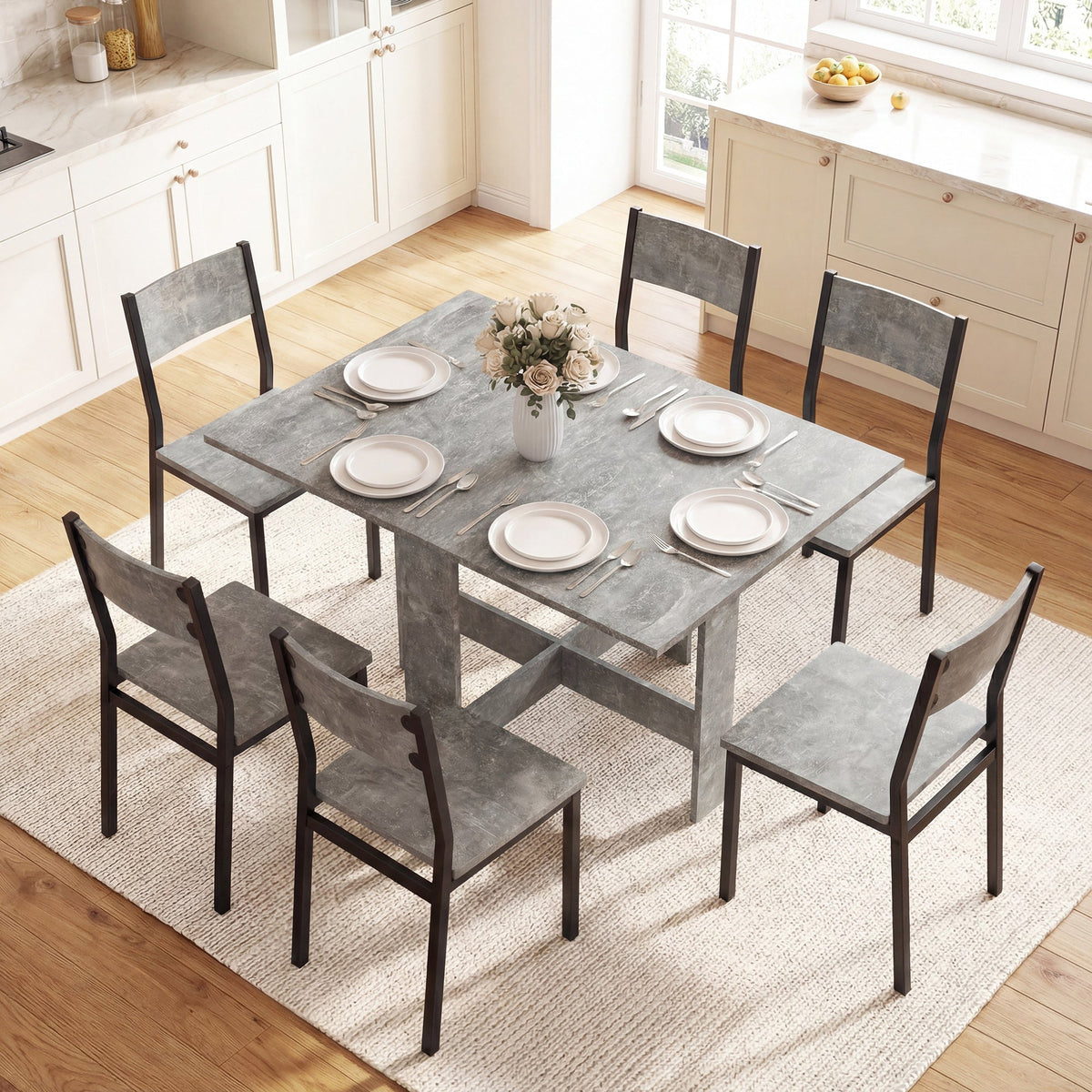 The grey dining table set up for six people in a bright dining room