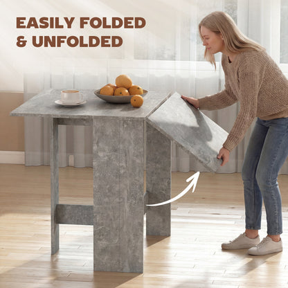 A woman easily folding one leaf of the grey kitchen table