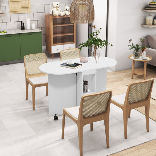 The white drop leaf dining table set up with four chairs in a bright kitchen setting