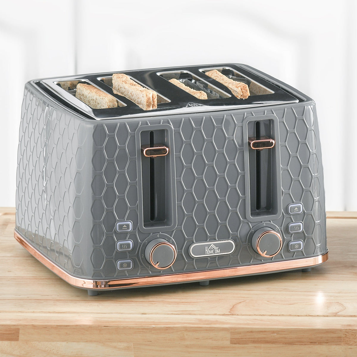 The grey four-slice toaster with toast popping up on a wooden worktop