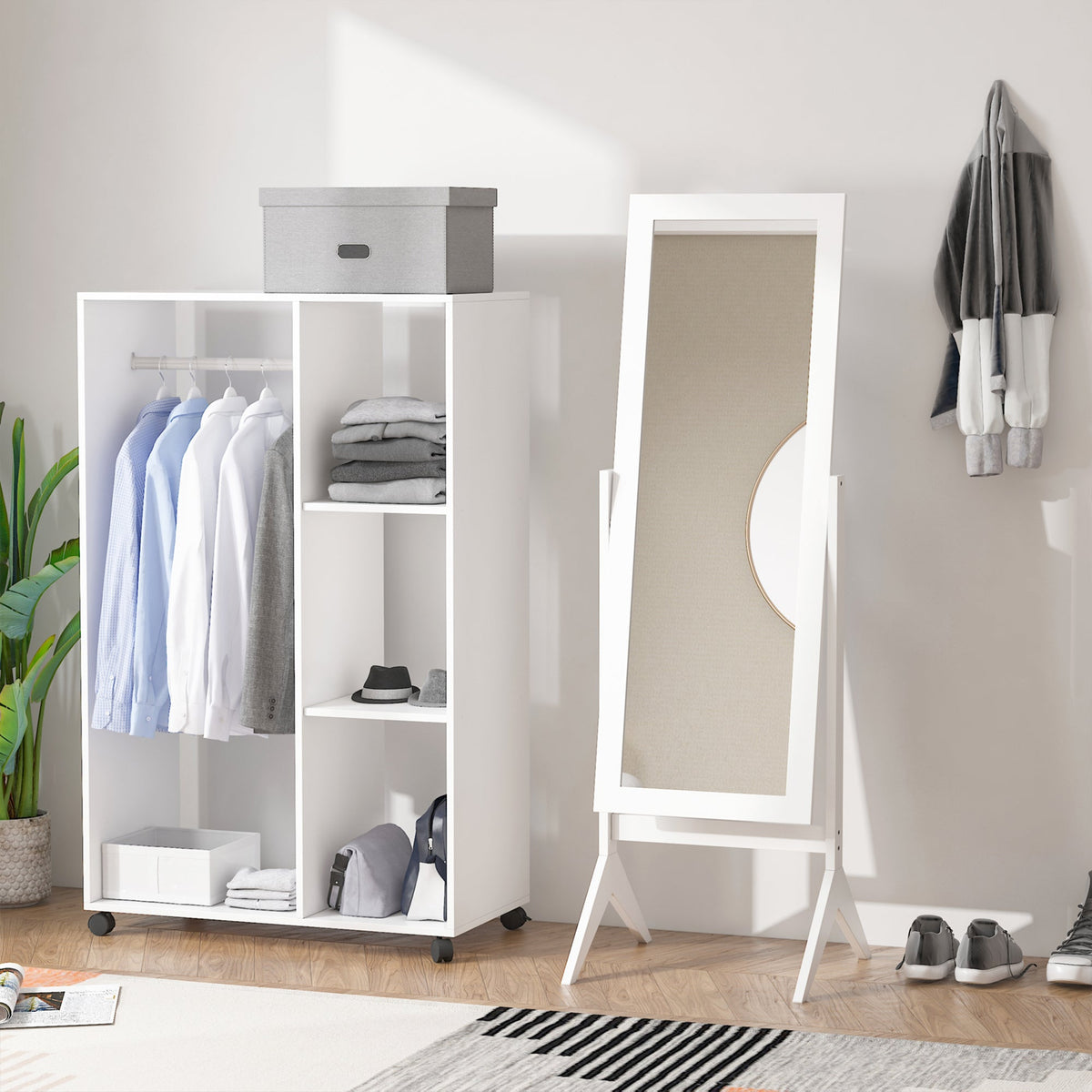 The white dressing mirror standing in a room next to a wardrobe unit