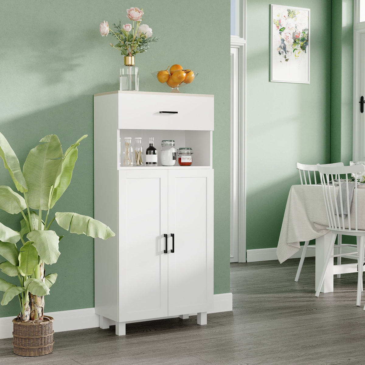 The kitchen furniture placed in a dining room with decor on the open shelf