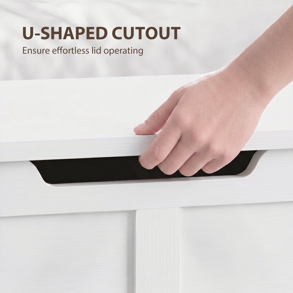A hand using the U-shaped cutout to lift the lid of the storage cabinet