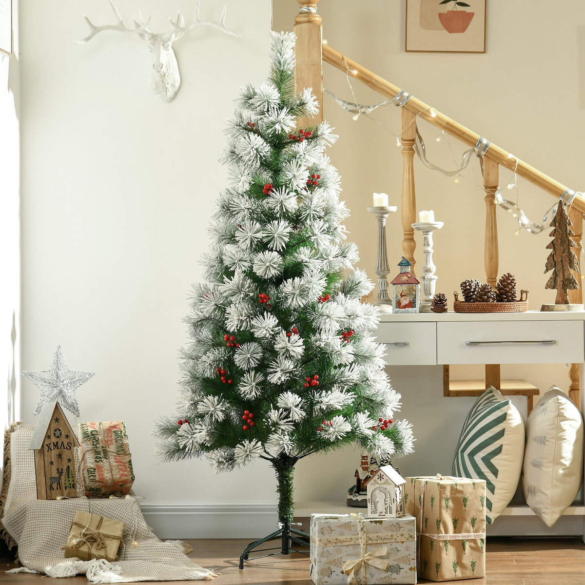 The white Christmas tree decorated with red berries is set up in a hallway next to a staircase