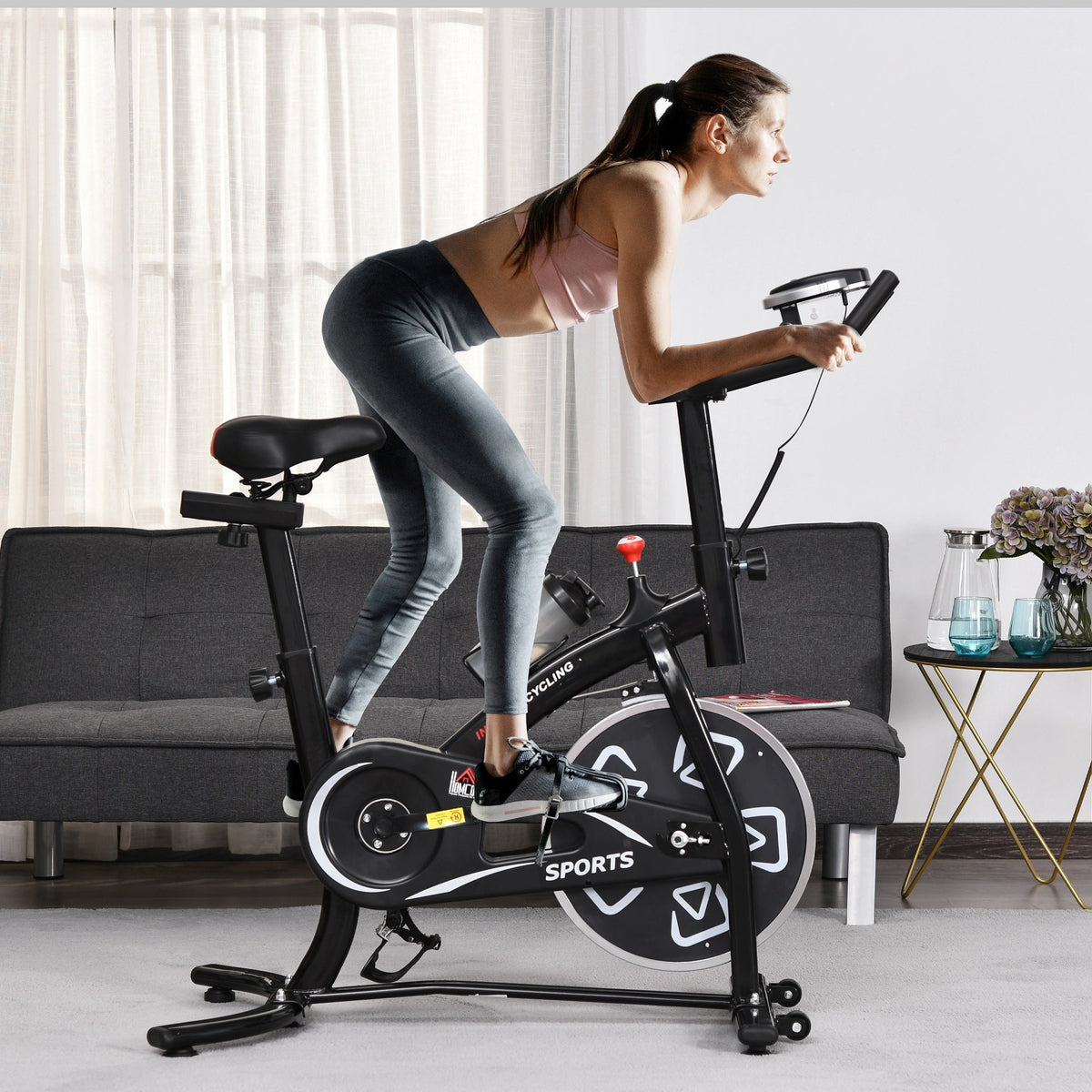 Woman exercising on the indoor exercise bike in a living room setting