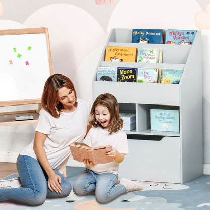 A mother and child reading a book next to the kids storage unit in a playroom