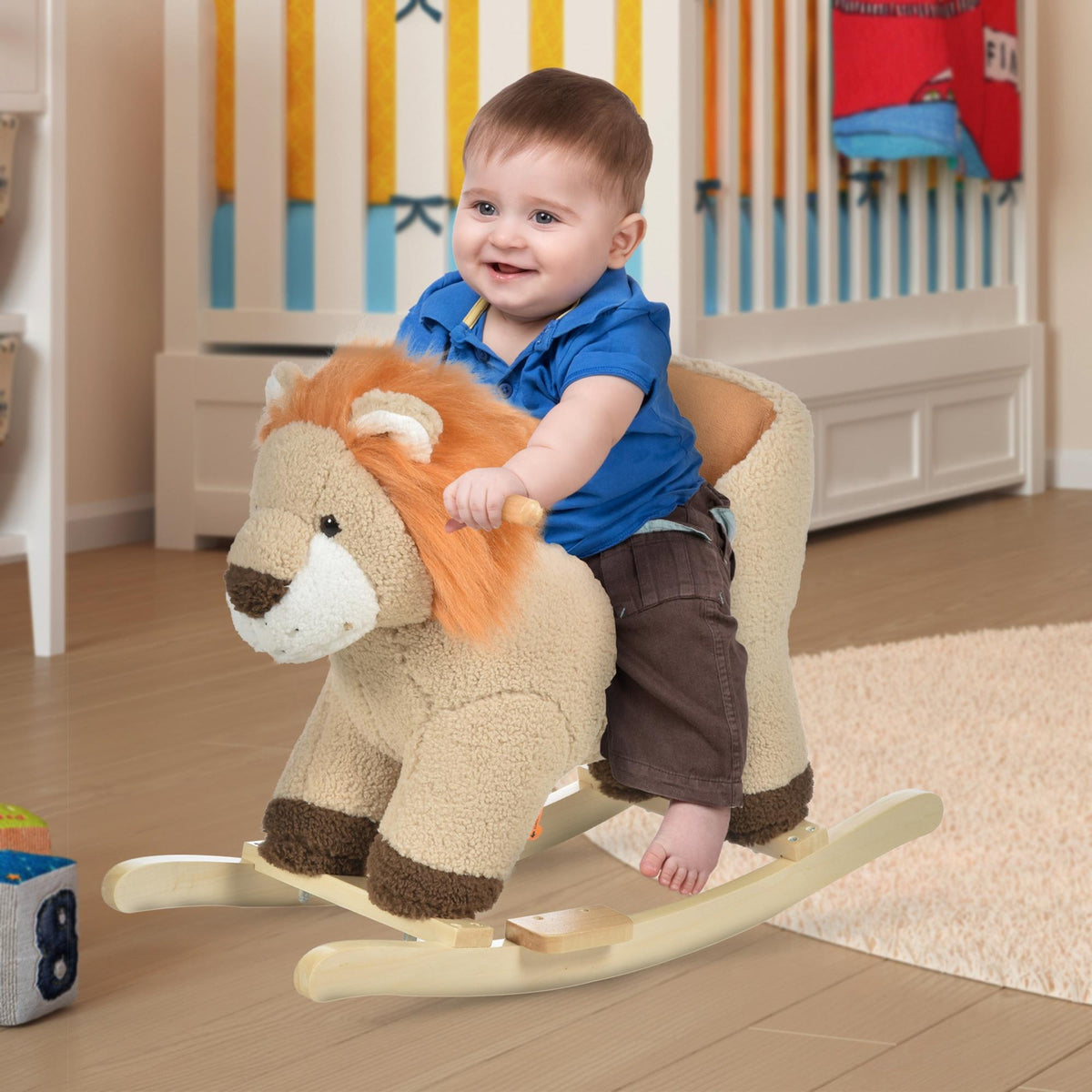 A smiling toddler sitting on the plush rocking animal in a nursery setting