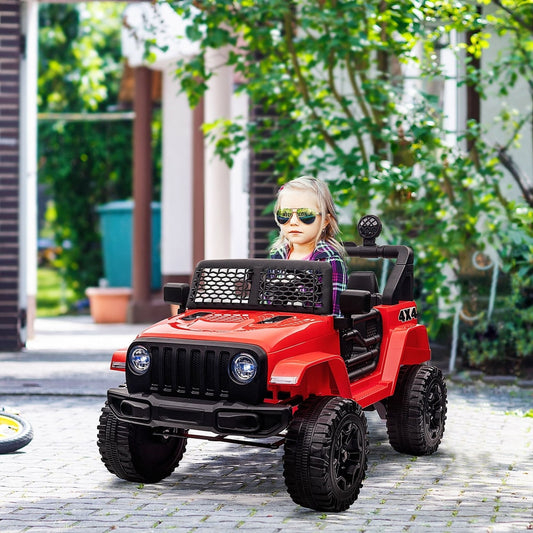 A young child wearing sunglasses sitting in the red ride-on car on a paved driveway