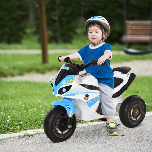 A young boy wearing a helmet rides the kids electric motorbike outdoors on a paved path