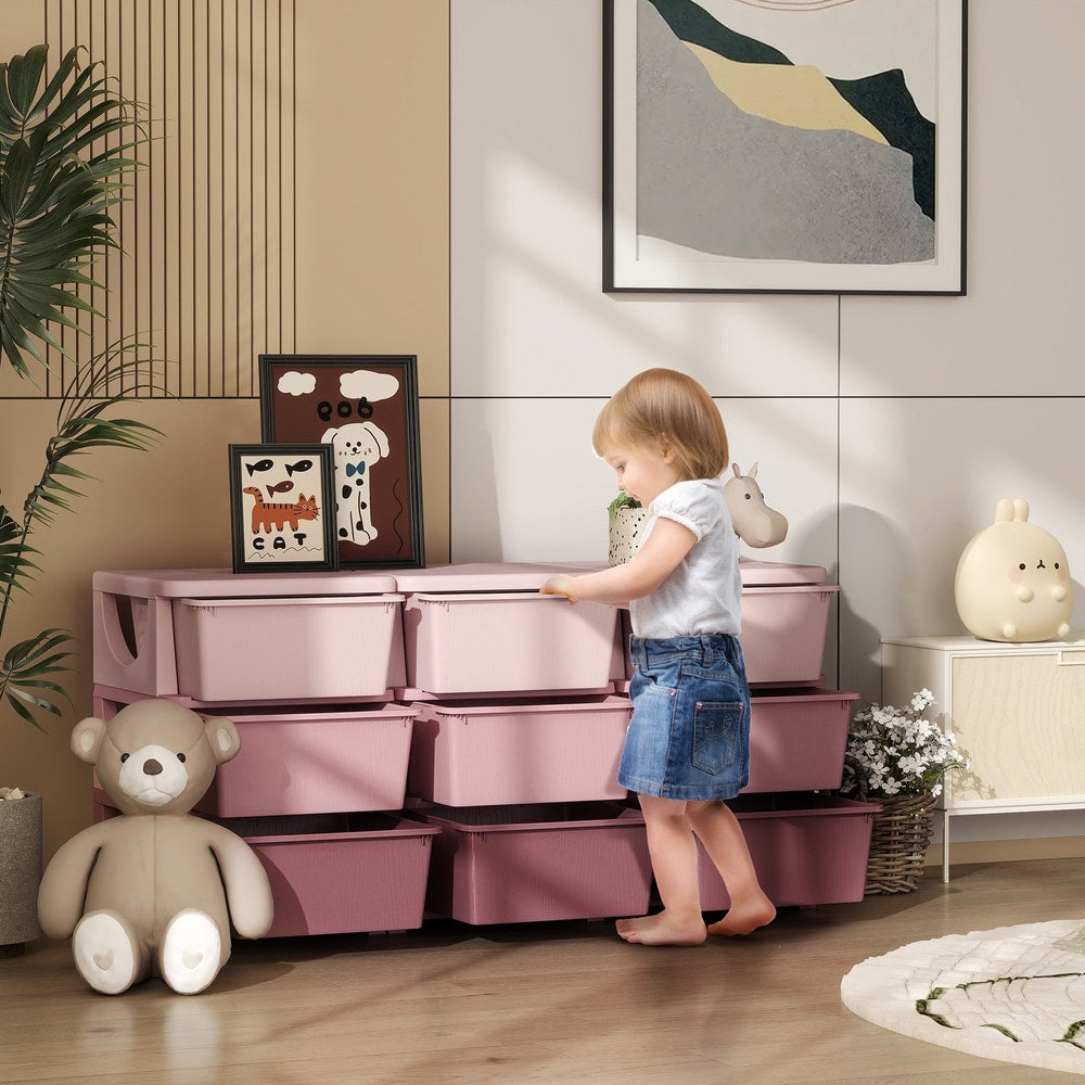 A young child pulls open a drawer on the pink kids storage unit in a bright room