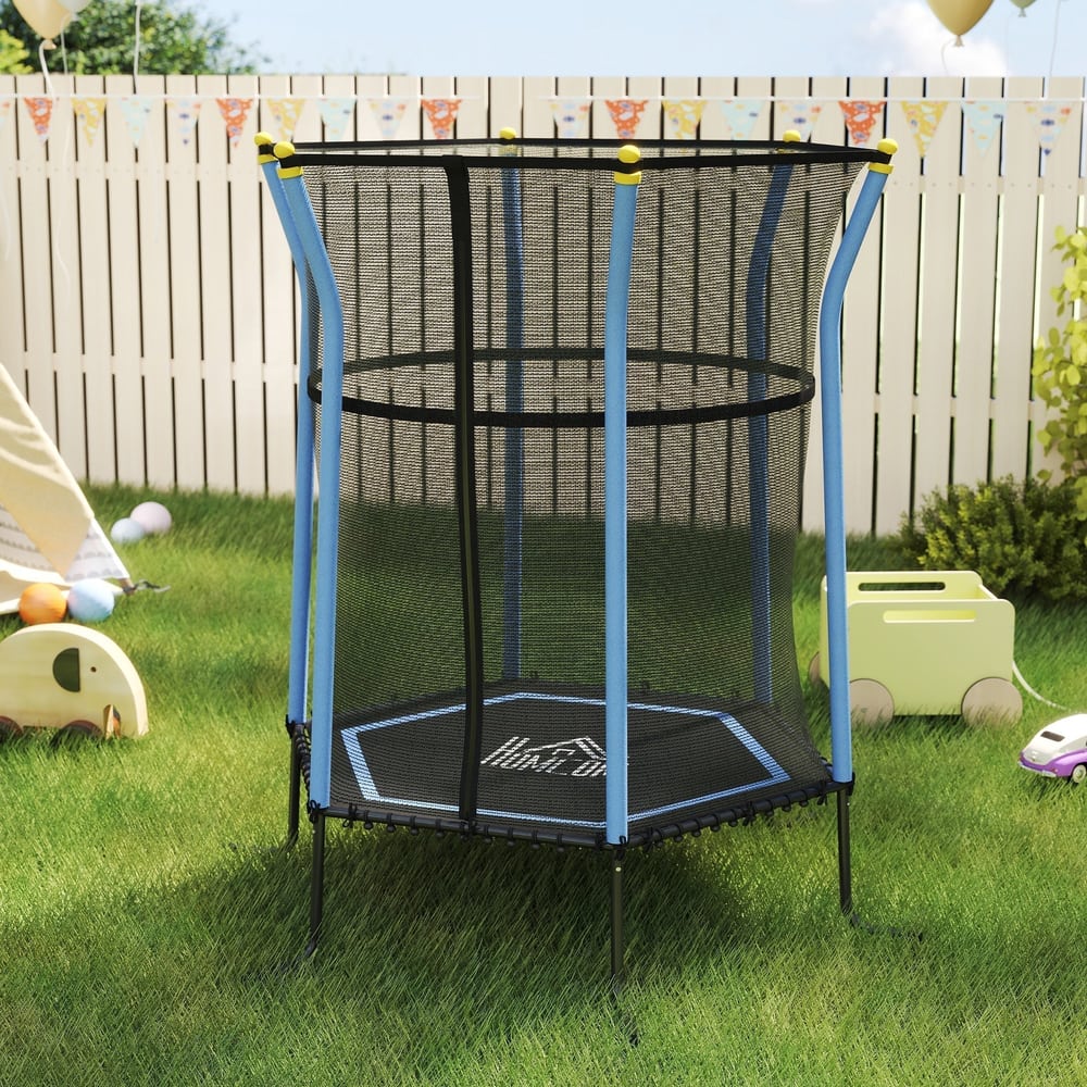 The blue kids trampoline bouncer set up on green grass with a white fence behind